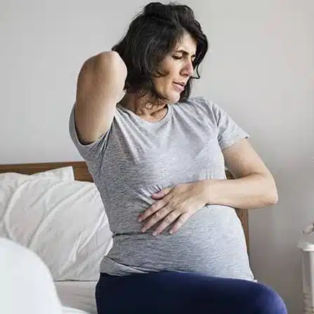 Pregnant woman suffering from backpain | prenatal chiropractic care in columbus