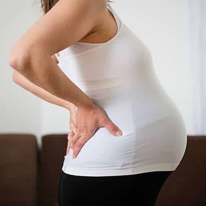 Pregnant woman suffering from back posture.