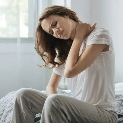 Woman holding her neck cause of severe neck pain