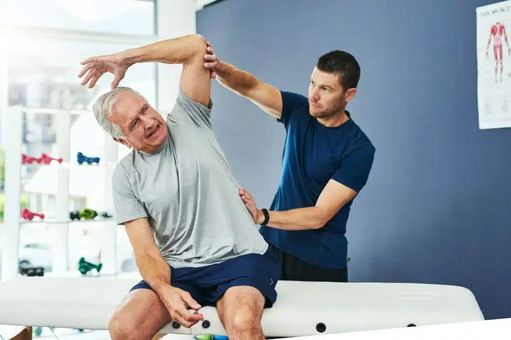 Chiropractor is having a physical therapy session with a patient suffers from bulging and spinal disc problem.