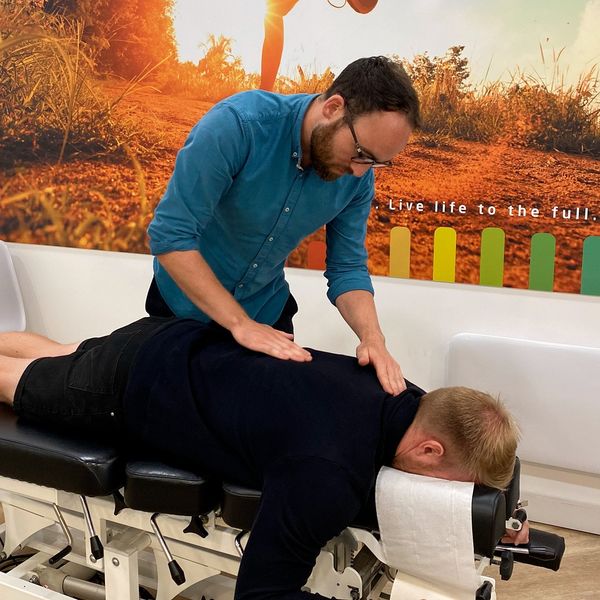 Chiropractor doing some LOGAN BASIC TECHNIQUE to the patient/ 
