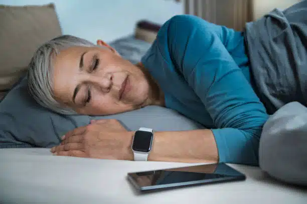 Senior woman sleeping on her bed.