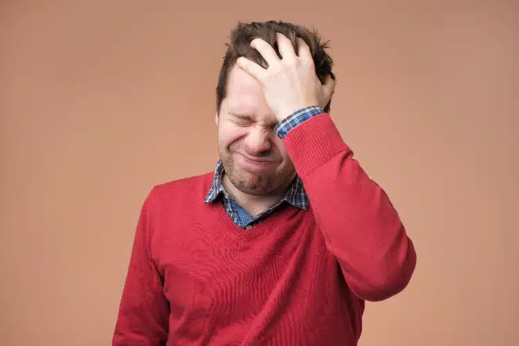 Man holding his head feeling of intense headaches and migraines treatment in columbus, ne