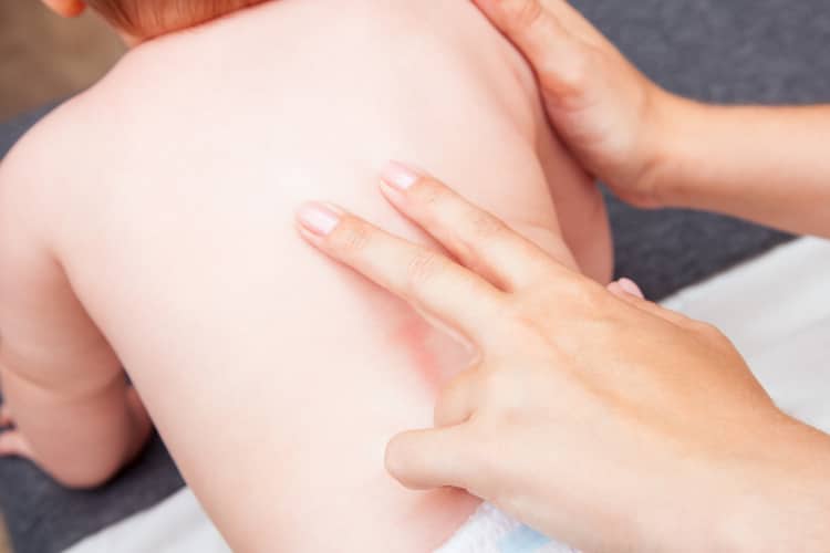 Pediatric chiropractor treating a young boy who suffers from Torticollis.