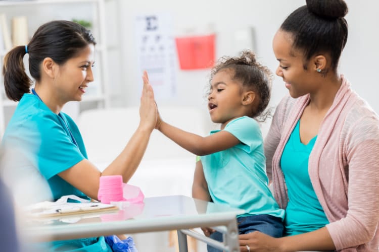 Mother and daughter having interaction with their pediatric chiropractor  . 