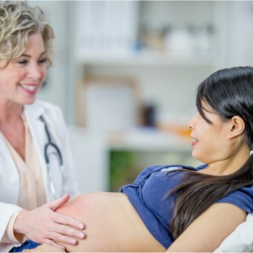 Pregnant woman receiving prenatal chiropractic care services.