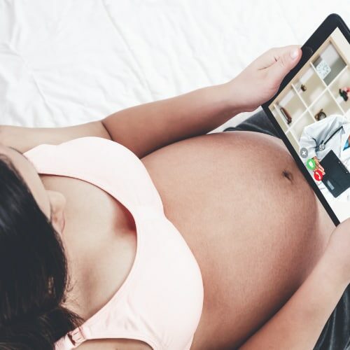 Pregnant woman watching reviews from a certain prenatal care online.