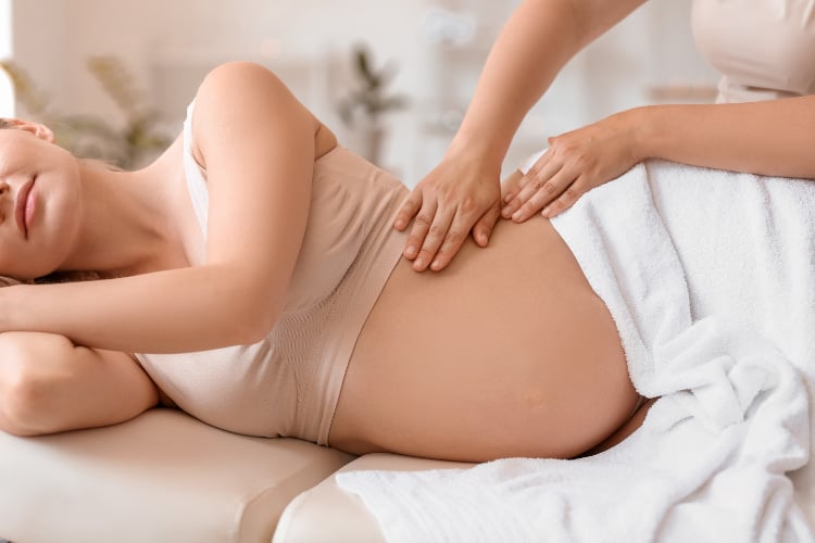 Pregnant woman receiing prenatal chiropractic care.