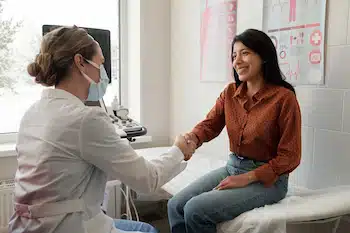 physical therapy speicalist shaking the hand of a patient after treatment