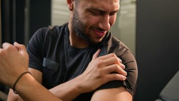 sporty man feel shoulder pain