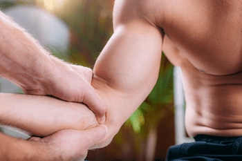 Chiropractic elbow adjustment on athlete