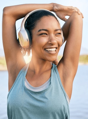 woman experiencing the benefits of chiropractic care: stretching arms by pulling elbow towards spine while exercising 