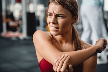 Unhappy athlete experiencing elbow pain