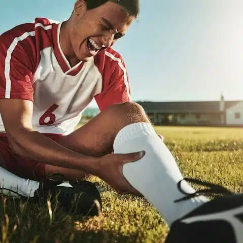 man playing soccer getting leg injury needing chiropractic treatment in Columbus 