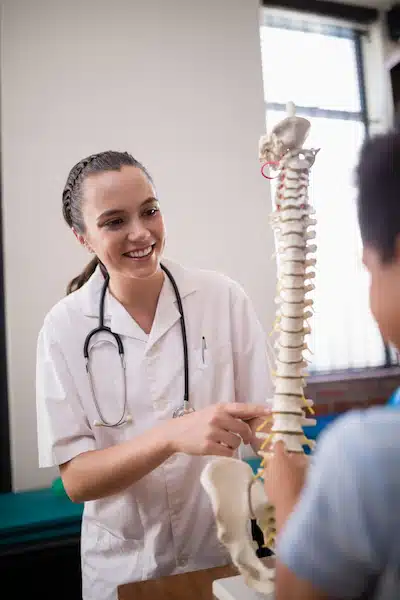 Explaining the procedure to a young patient - scoliosis treatment in Columbus