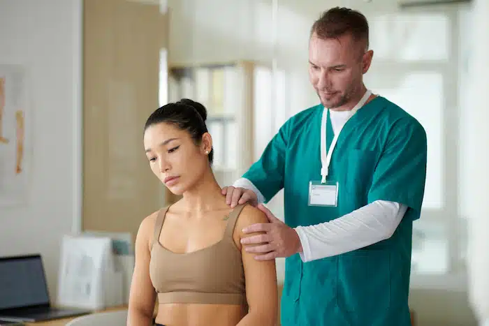 therapist palpating neck and shoulders