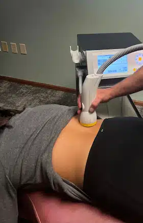 woman with chronic back pain treated with SoftWave TRT therapy in Columbus