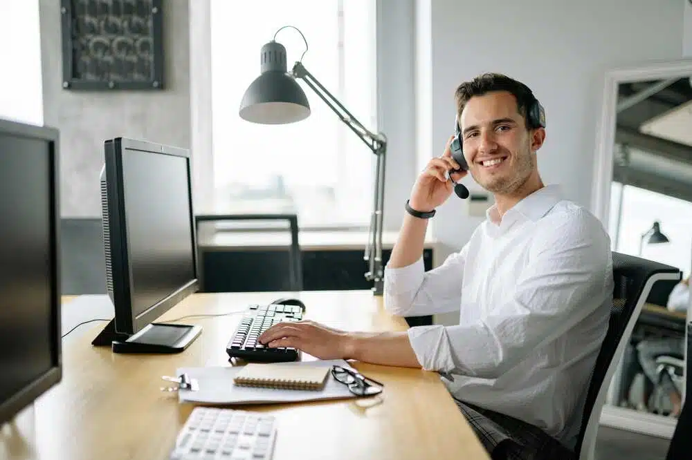 A male desk worker is happy at work