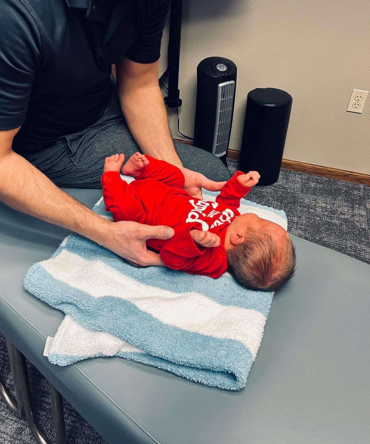 Baby boy with developmental delays lying on bed | pediatric chiropractic care in columbus