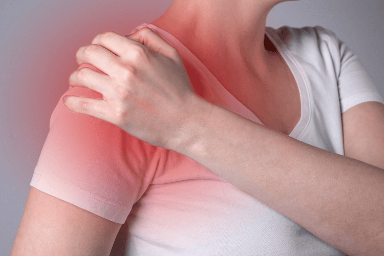 Person holding their shoulder with a red highlight indicating shoulder pain or inflammation